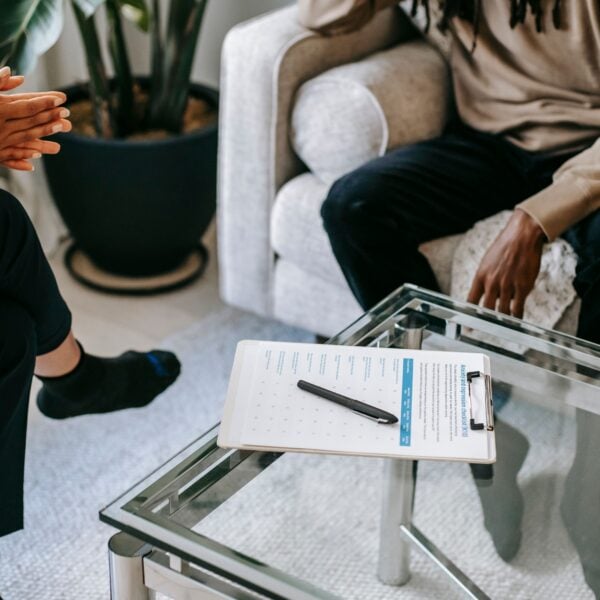 A person talking with a counsellor during a trauma therapy session