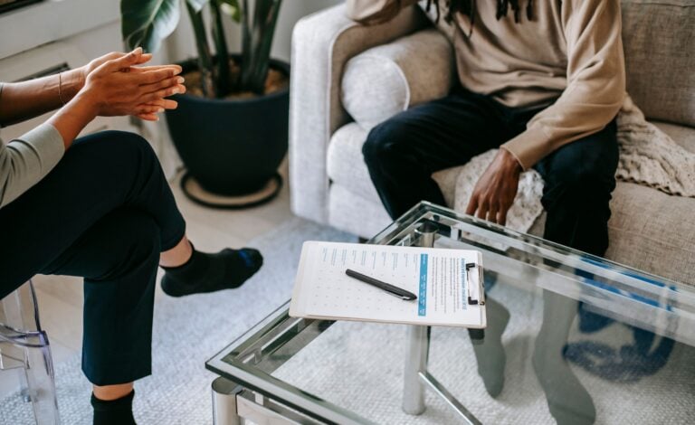 A person talking with a counsellor during a trauma therapy session